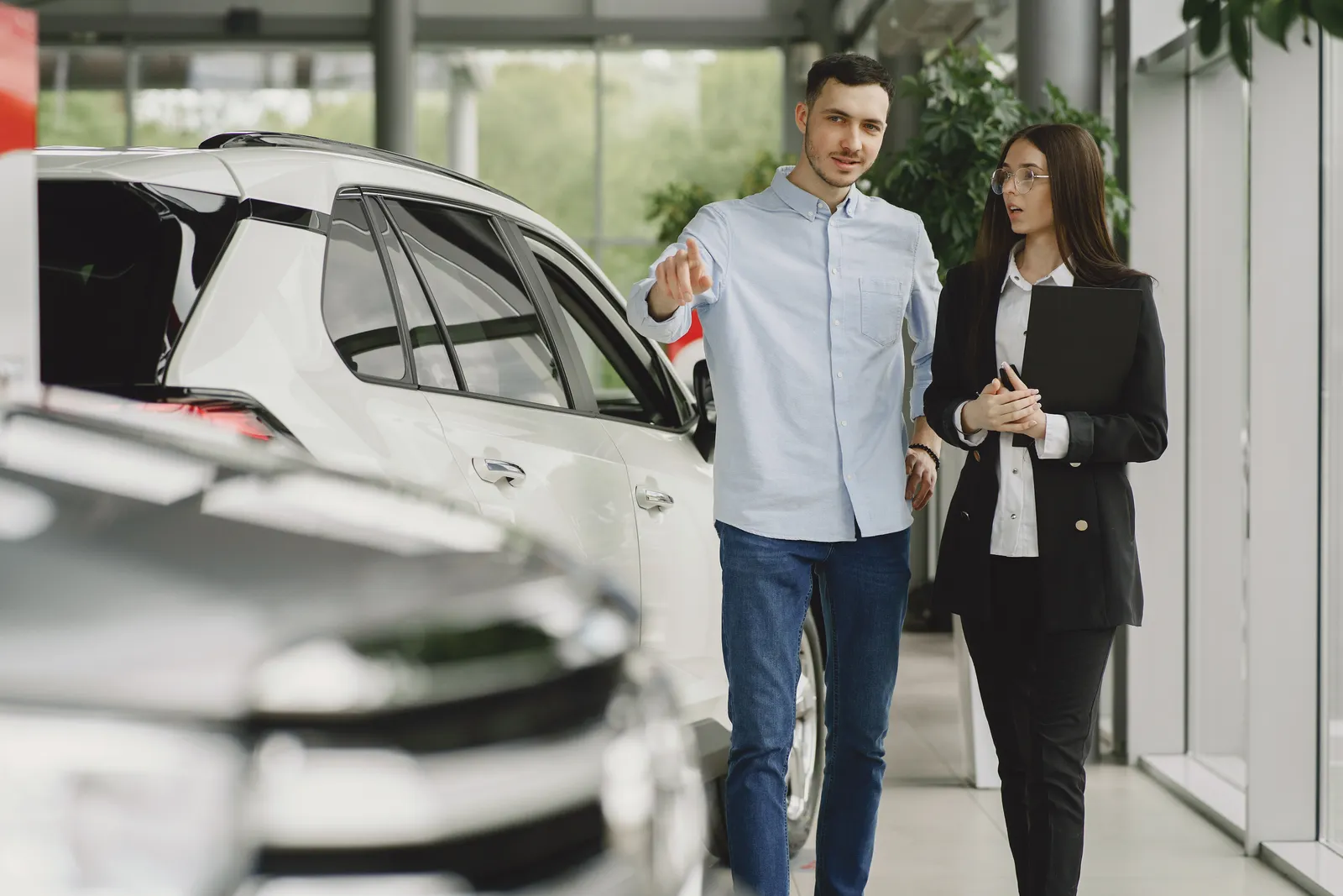 A customer and dealership professional discussing a vehicle